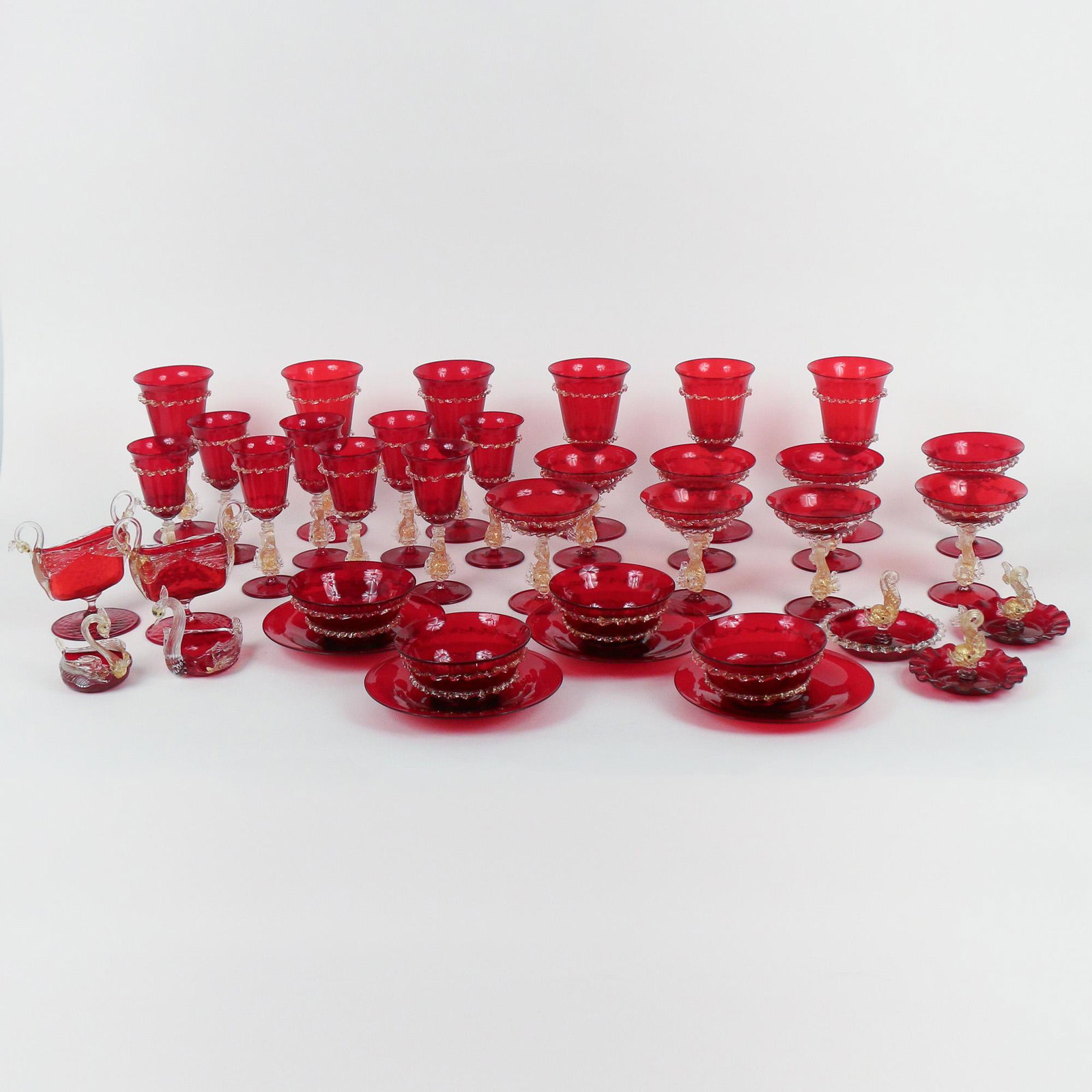 (37pc) SET OF RED & GILT VENETIAN GLASS STEMWARE: including six goblets (7-1/2 in. height); eight white wine glasses (6-5/16 in. height); eight sherbets (4-1/2 in. height); four finger bowls (4-1/2 in. diameter) and four plates (6-3/4 in. diameter); 
