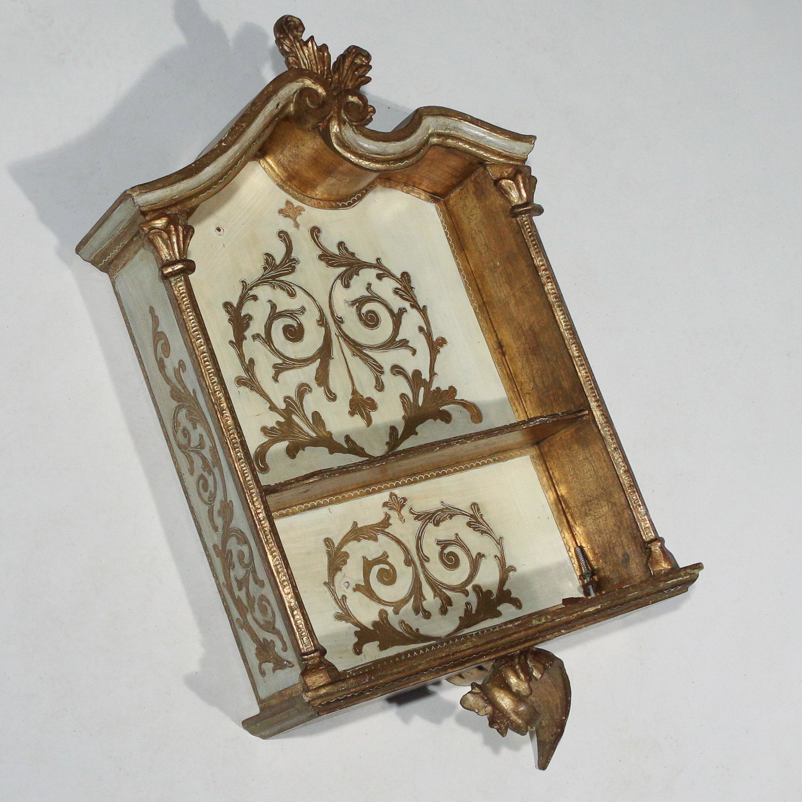 ITALIAN ROCOCO OPEN WALL SHELF: sculpted pediment with finial, two shelves, white paint and gilt decorations h. 27 w. 16-1/2 d. 4-1/2 in.