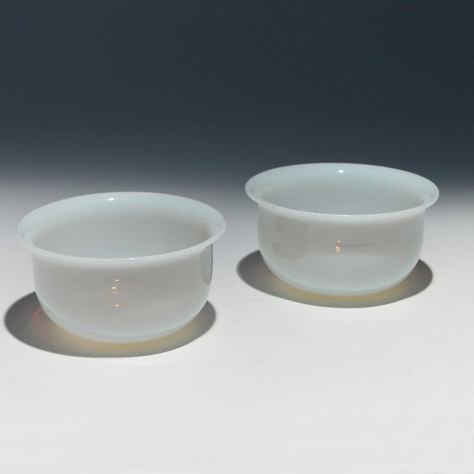 PAIR CHINESE PEKING GLASS BOWLS: 20th century, simulated white-jade-color, on stands h. 2-3/4 dia. 5 in. Provenance: Estate of John F. Ball, Television and Film Production Executive, Greenwich, CT