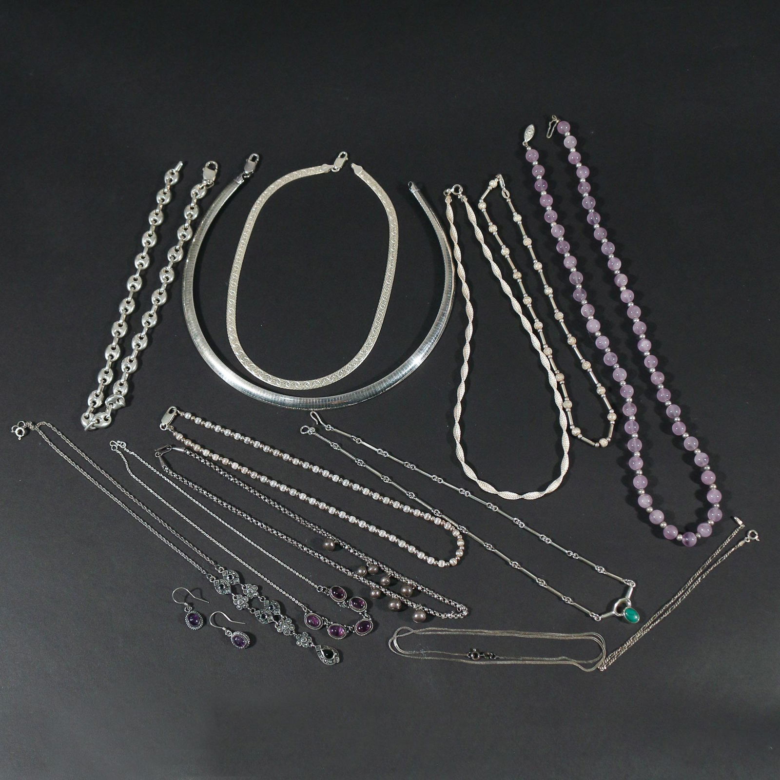 LOT STERLING SILVER NECKLACES: Including an anchor chain link necklace (16 in.), a chain and link pendant necklace with marcasite (18 in.), a Mexican sterling link necklace with malachite, a sterling chain with four links of oval a