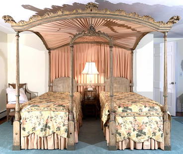 SHERATON STYLE CARVED & POLYCHROME TWIN BEDSTEAD: late 19th/ early 20th century; after a design by Thomas Sheraton originating in 1793, described by him as "a summer bed in two compartments" having full pagoda carved canopy with archway crested by a