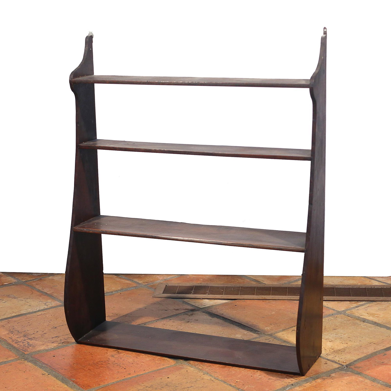 AMERICAN MAHOGANY HANGING WHALE SHELF: 19th century, hanging wall shelf with figured whale sides supporting four shelves h. 33 w. 26-1/4 d. 8-1/4 Provenance: the estate of a South Salem, NY lady