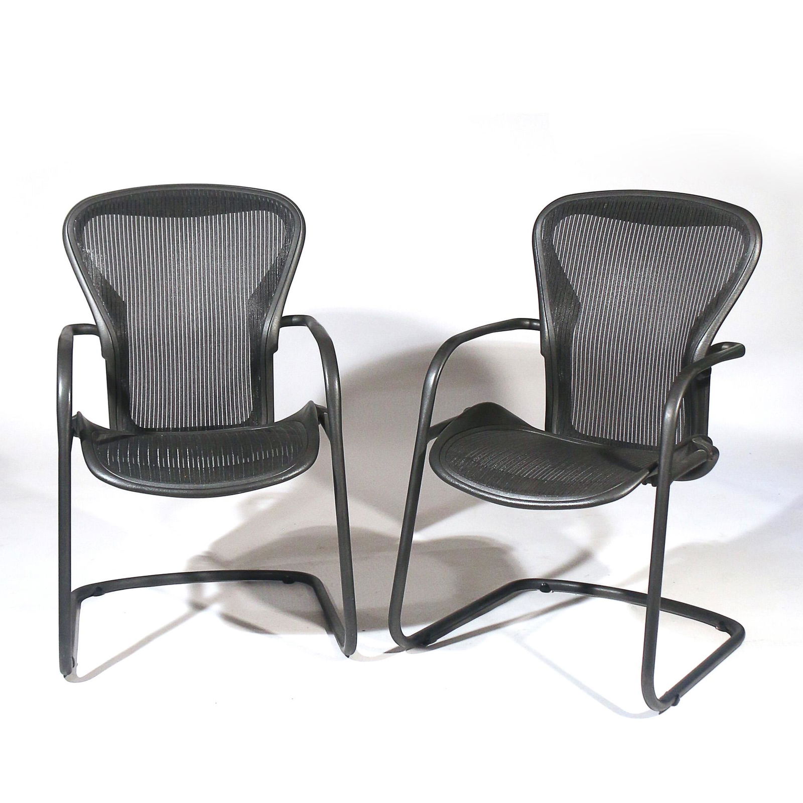 PAIR HERMAN MILLER AERON SIDE CHAIRS: black tube frame arm chairs with webbed seats h. 38 w. 22-1/2 d. 27 in. Provenance: Private collection, Weston, CT Limited Preview: Please note that this auction has a limited in-person preview. Not a
