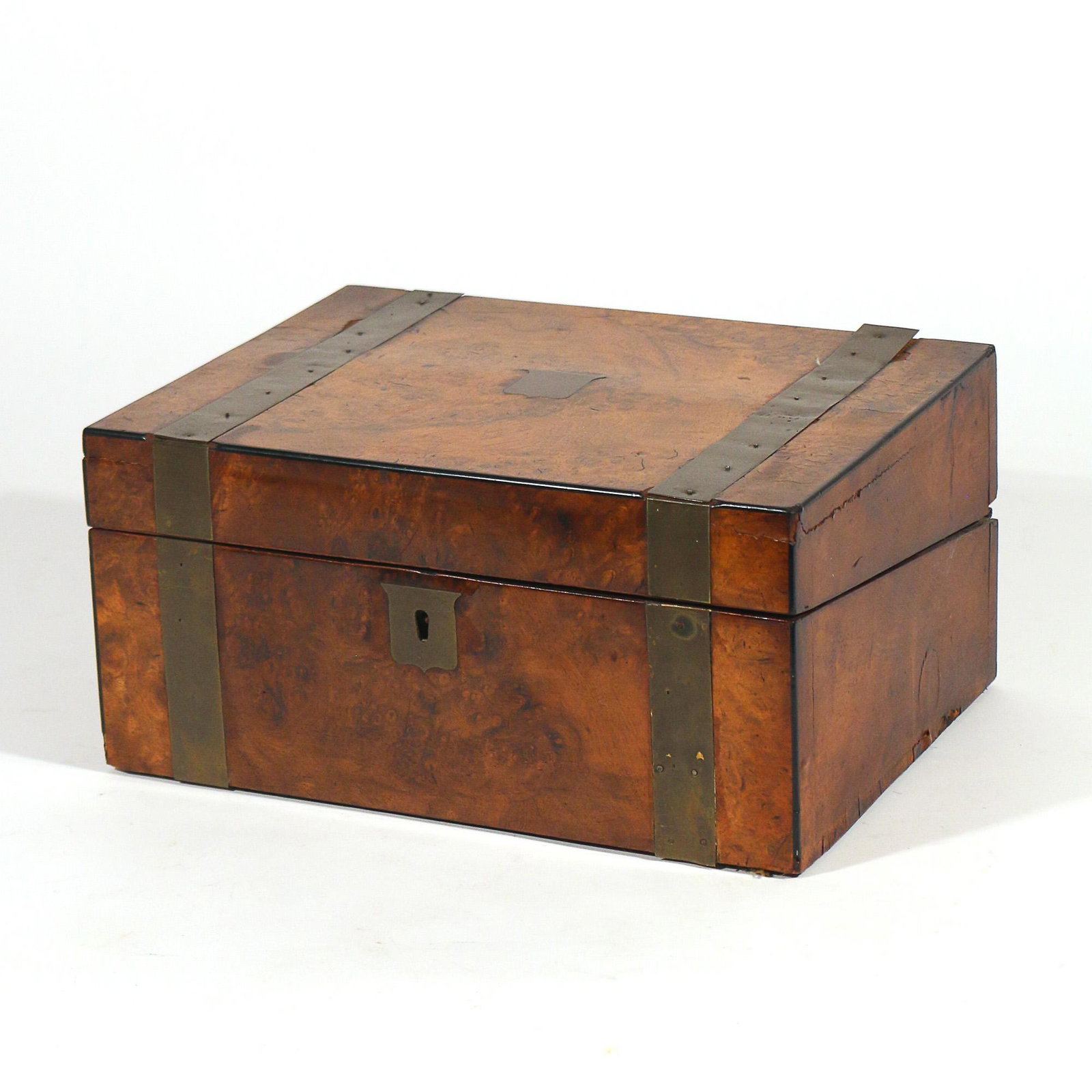 BURL WOOD TRAVEL WRITING BOX: 19th century or earlier, burl veneered with brass banding and shield-form escutcheon, interior with black tooled leather writing surface and compartments, having a Secure Lever locking mechanism h. 6 
