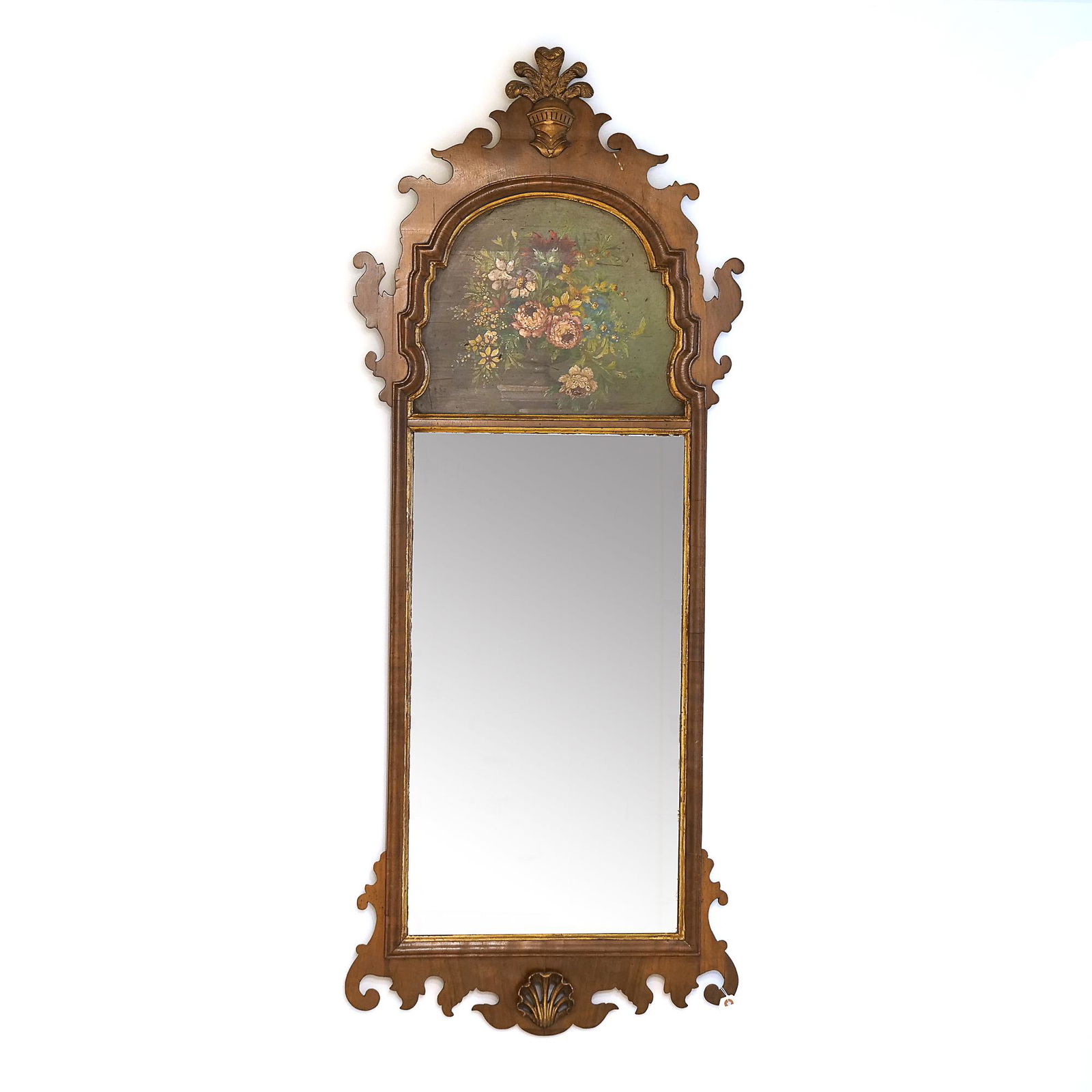 FRETWORK WALL MIRROR, CRESTED BY FLORAL STILL-LIFE: with carved knights helmet at the top and shell carving at the bottom, the still life depicting pink chrysanthemums and other flowers in a vase h. 60 w. 24 in. Provenance: the estate of an important G