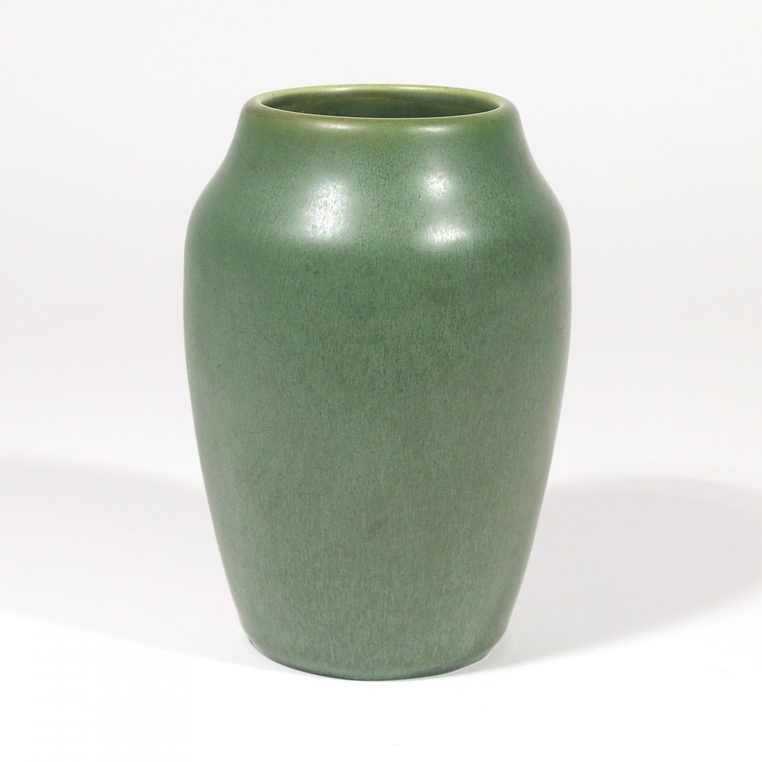 GREEN HAMPSHIRE POTTERY VASE: in a gradient design, darkest at the bottom and lightest at the top; marked "Hampshire Pottery / M" on the bottom h. 7-1/2 w. 3-1/2 d. 5 in. Provenance: items descended through the families of a Green