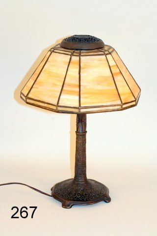 267) TIFFANY STUDIOS BRONZE ZODIAC PATTERN DESK LAMP: W/ CARAMEL GLASS PANELS; COND.: 4-PANELS W/HAIRLINE CRACKS, H.16", SHADE H.5", DIA. 11"
