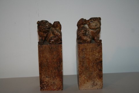 88) PR. 19C SOAPSTONE SEALS CRESTED BY FOO LIONS: CARVED SOAP STONE, H 7"; SIDE ENGRAVED, SEALS INTACT, BOTH W/CHIPS ON BASE & 1 W/FLAKES ON FOO LION