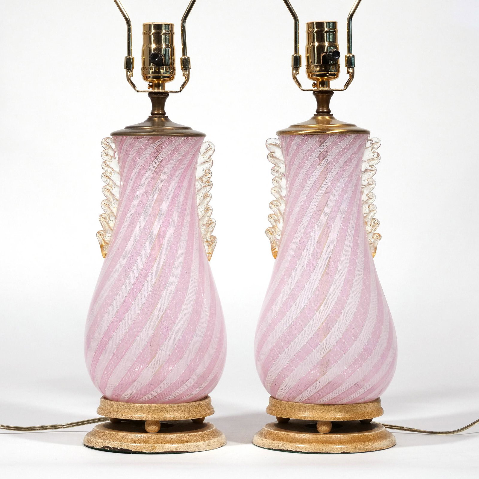PAIR VENETIAN GLASS VASES CONVERTED TO LAMPS: blown pink and clear glass in a twisted pattern h. 17 in. (over socket) overall: 28 in. (over harps) Decorative Arts
