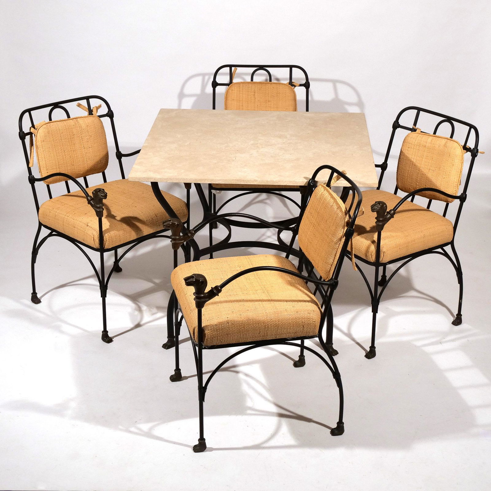 J-ART IRON COLLECTION TABLE & CHAIRS: "Beryllia Collection," having lion’s head terminals, the table with a travertine top; h. 33 x 21 x 24 in. (chairs) h. 30 w. 36 d. 36 in. (table) Furniture