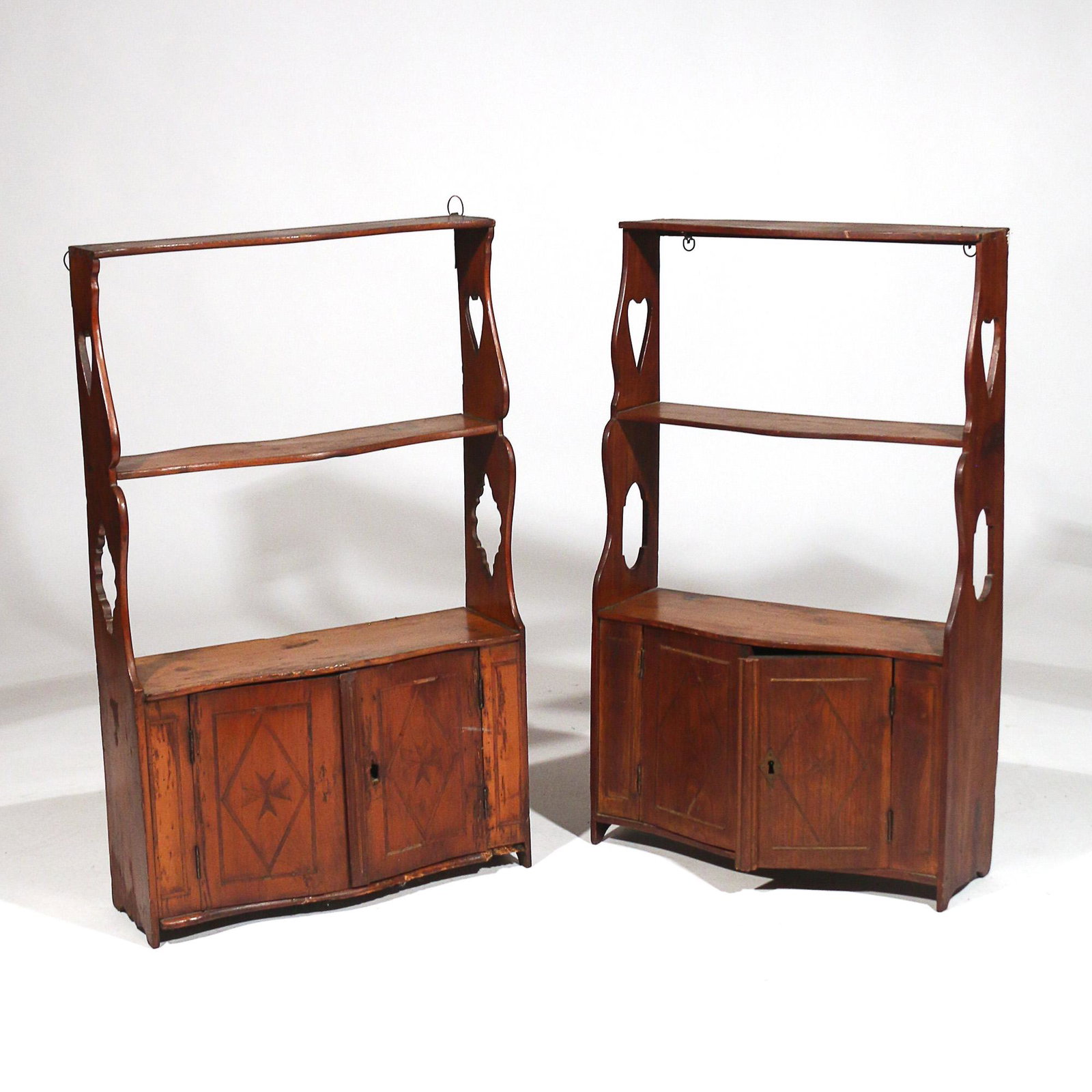 NEAR PAIR E. 19TH C. WALL CABINETS of SMALL SIZE: E.19th century, continental; one with diamond inlaid double doors, the other with Maltese cross inlaid doors; both with open work sides h. 30 w. 18 d. 6 in. (largest) Provenance:the estate of an impor