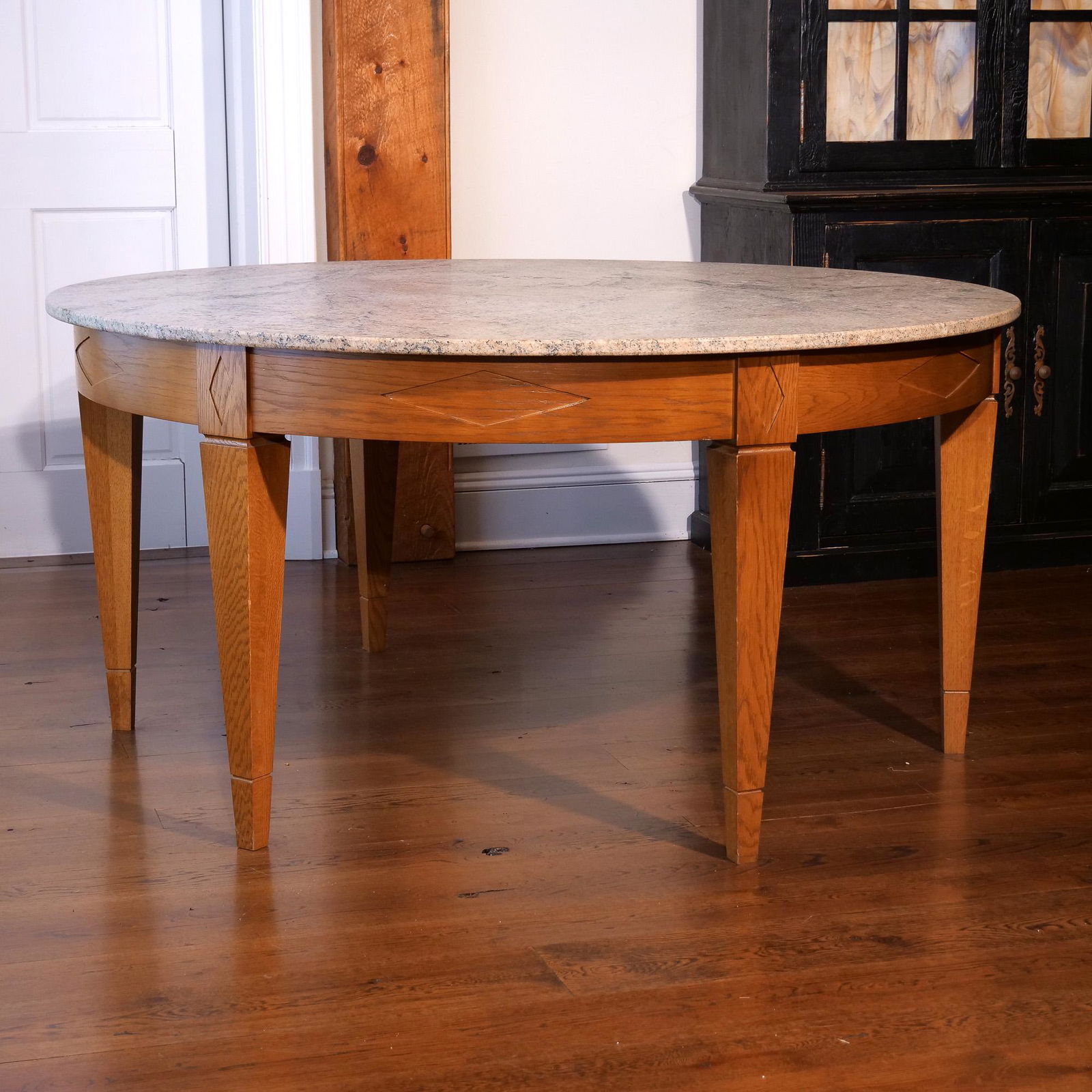 ROUND MARBLE TOP DINING TABLE: round marble top on a conforming round frame with diamond patterned reserves resting on six tapering legs h. 29 dia. 60 in. Provenance:from Herringbone Creative, Bedford NY; the private offices of Mr.