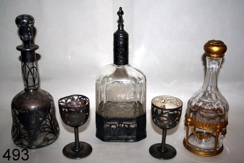 493) LOT: SILVER OVERLAY DECANTER, READS: FROM JESSIE J: PLUS 2-GLASSES, 1-W/DMGD.; 2ND DECANTER W/ORMOLU FRENCH GILT TROPHY MOUNTS; PLUS 3RD. DECANTER W/SILVER PLATE SURROUND