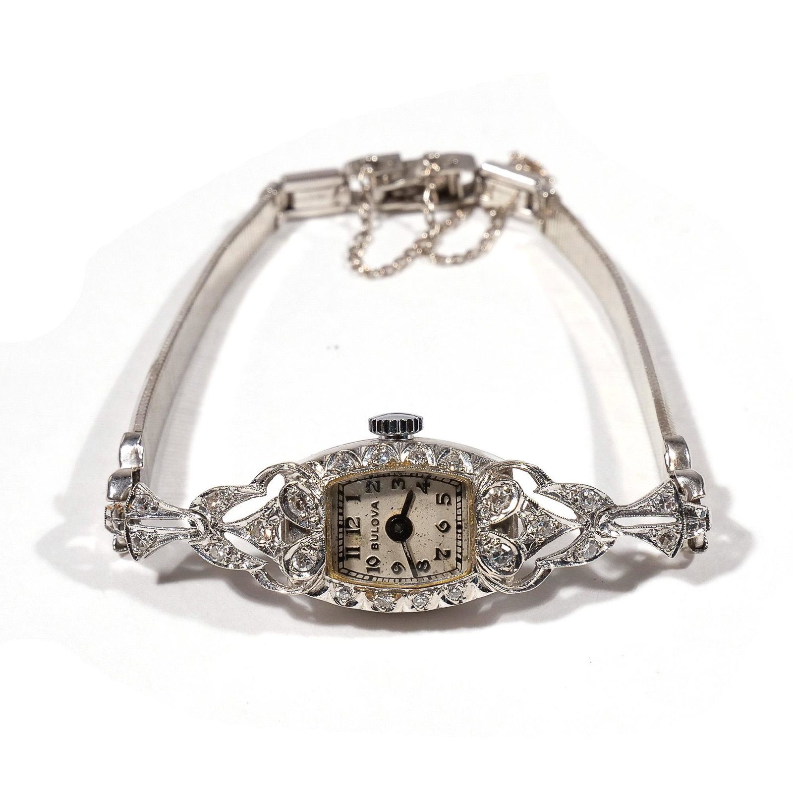 BULOVA DIAMOND & GOLD LADY'S WATCH: Having a 14k white gold case mounting diamonds on a metal band; case marked 14; total weight 14.7g Provenance: Private collection, Chappaqua, NY Limited Preview: Please note that this auction has a li