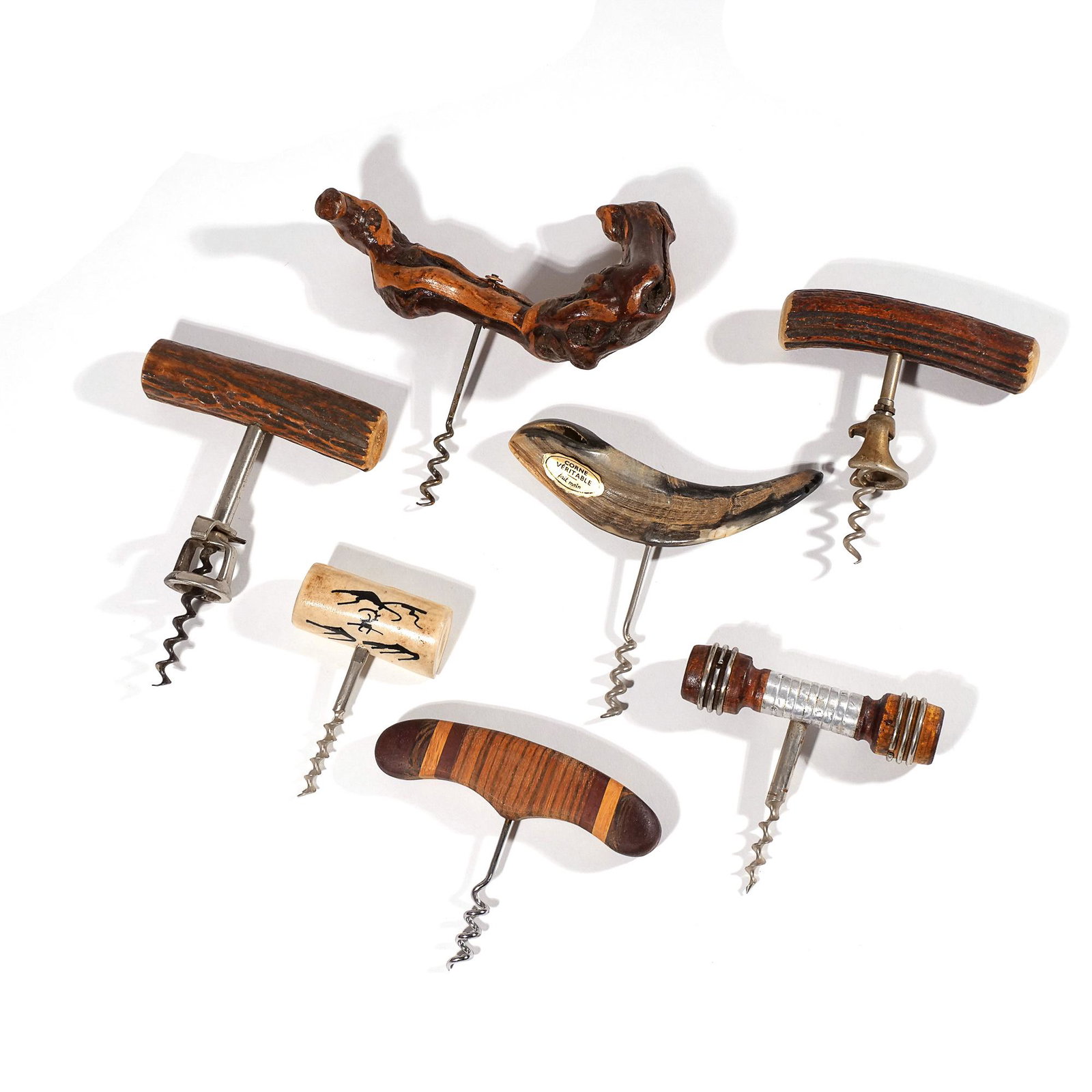 (7pc) HORN & OTHER CORKSCREWS: Pull type bottle openers, including 3 horn, 1 decorated bone, 1 polished driftwood, and 2 decorated wood w. 7 in. (largest) Limited Preview: Please note that this auction has a limited in-person previ
