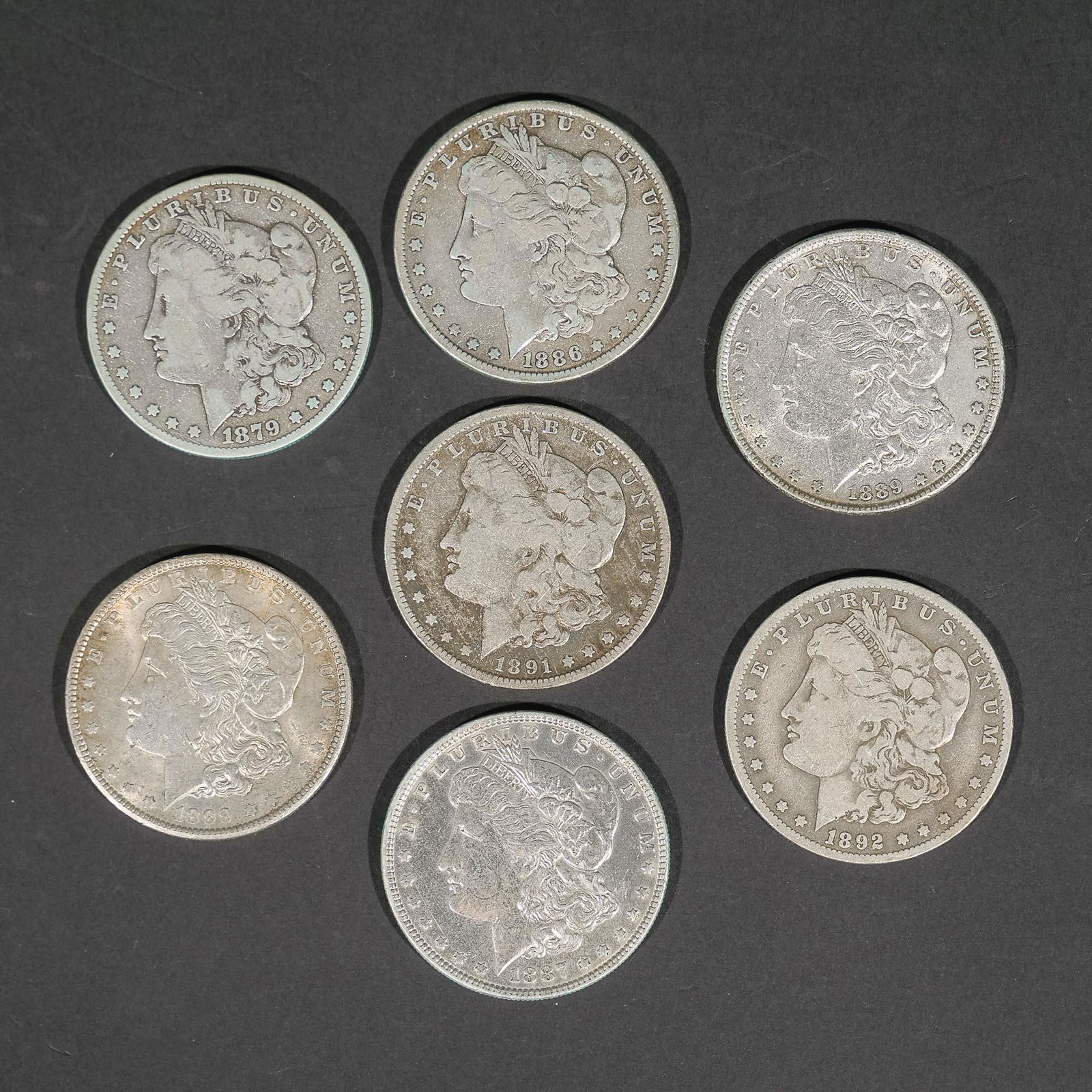 (7pc) 1879-1899 SILVER MORGAN DOLLARS (1 of 2)