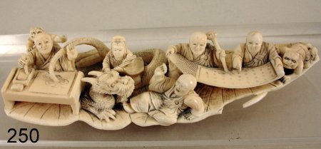 250) 19TH C. IVORY CHINESE CARVING, SHOWING ENTWINED : SERPENT, DEMONS & SCHOLARS, MOUNTED ON LILY PADS, SGD., COND.: LEAD STEM BREAK & THUMB CHIP ONE FIG., L. 6", W. 2", H. 1 1/2"