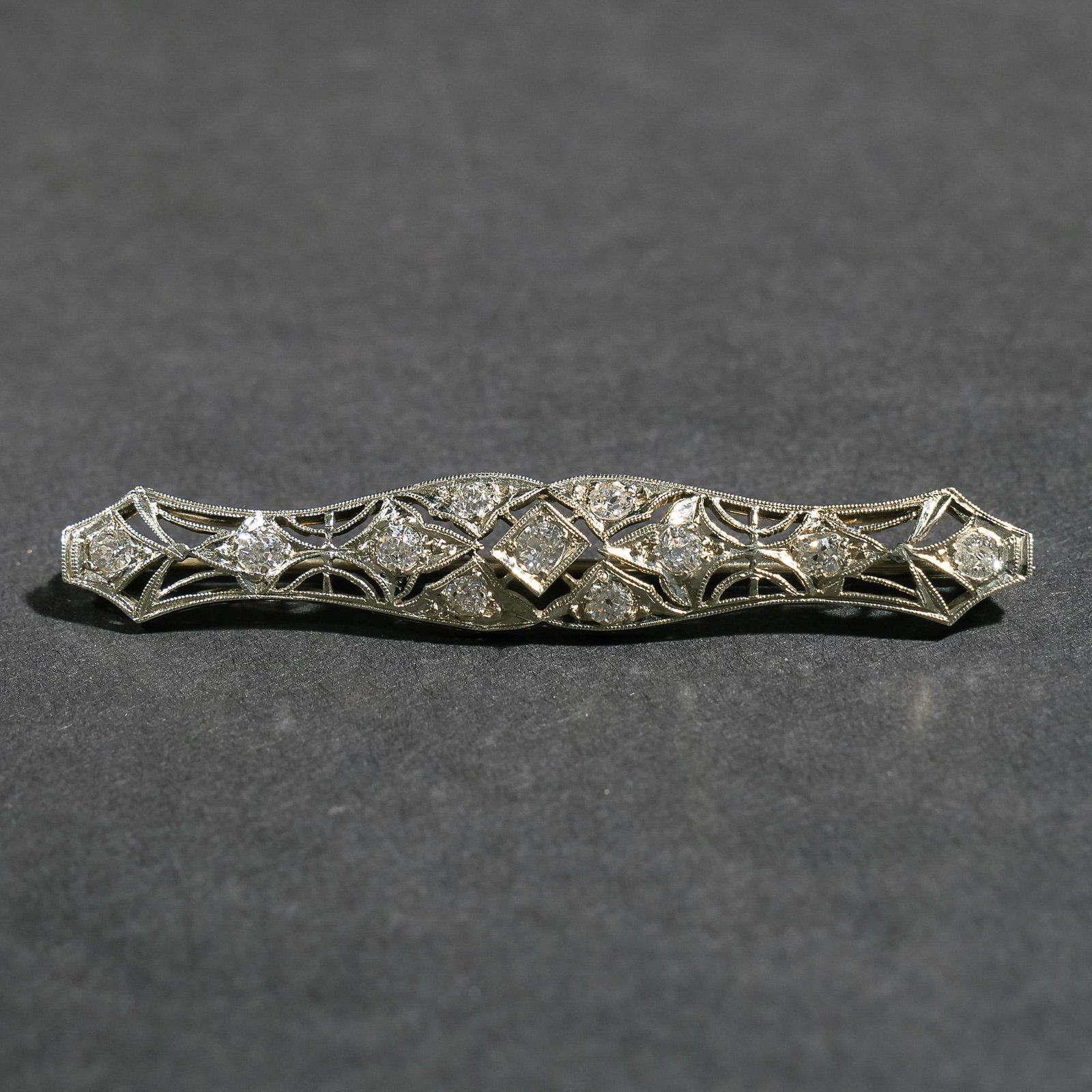 DIAMOND & WHITE GOLD BAR PIN: Set with round brilliant cut diamonds in an openwork 14k white gold bar pin; 2-1/4 in., 5.4g Provenance: Descended through a Scarsdale, NY estate