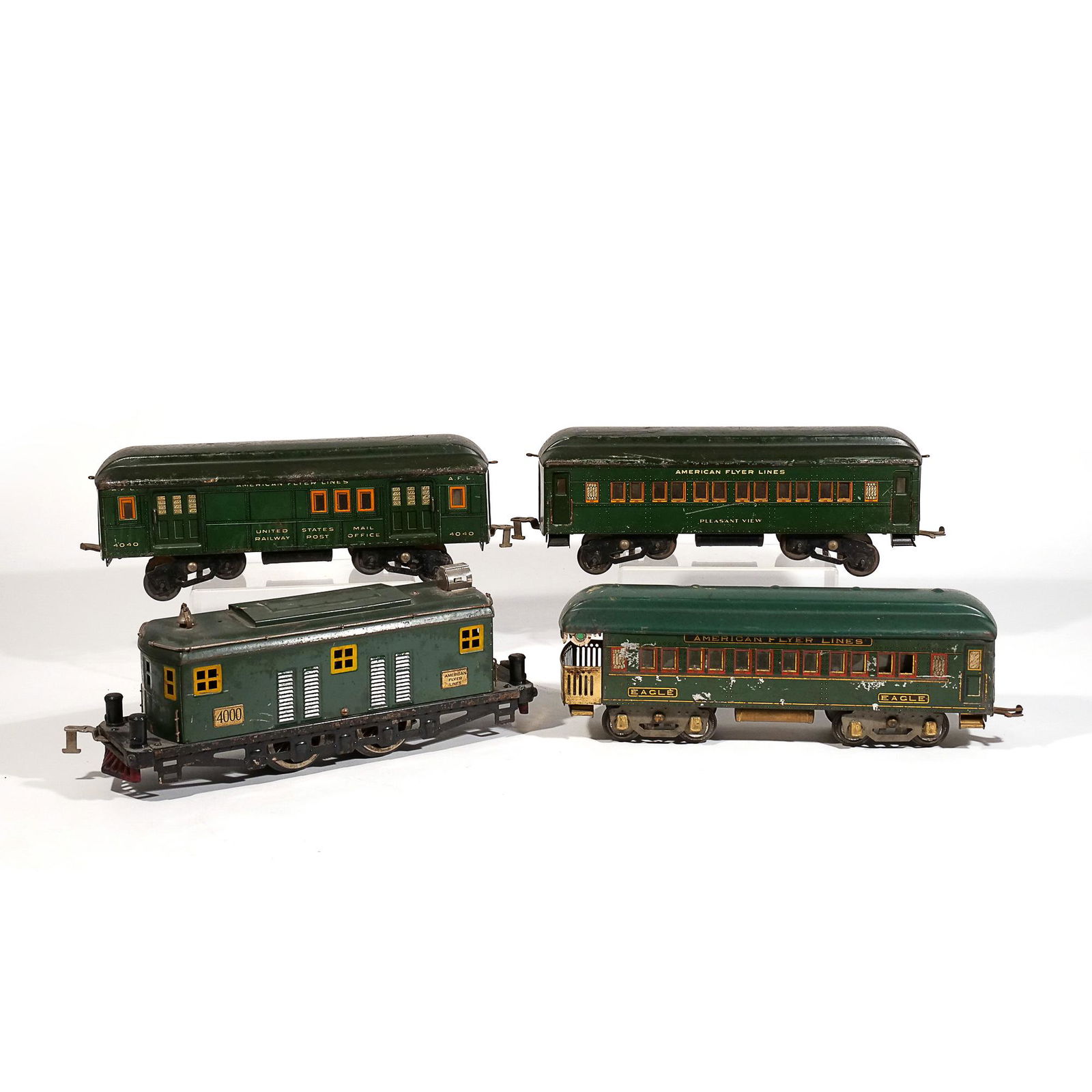 (4pc) AMERICAN FLYER LINES TRAIN SET: Chicago, Illinois, four cars all in green paint, including engine No. 4000, car 4040, car "Pleasant View," and "Eagle" caboose w. 14 in. (largest) Provenance: Descended through a Pleasantville, NY est