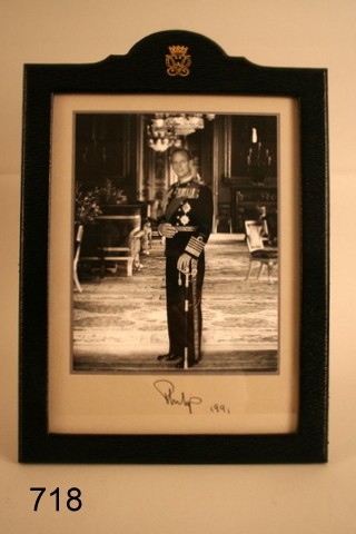 718) PAUL LONGMIRE, EASEL BACK BLUE LEATHER FRAME : W/SGD. PHOTOGRAPH OF PHILIP DUKE OF EDINBURGH, SGD. & 1991, OVERALL SIZE OF FRAME: 14 X 10"