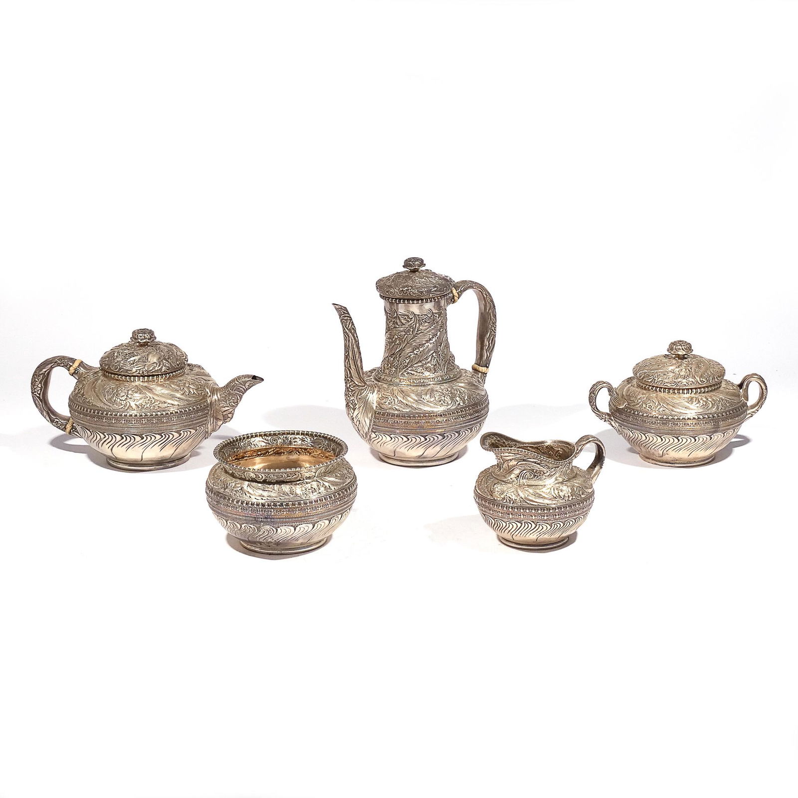 (5pc) RARE TIFFANY & Co. SILVER TEA & COFFEE SET: Service set, ornately sculpted, comprising a coffee pot (no. 6350 / 3609) and a teapot, each with bone insulators; plus a large covered sugar, open creamer, and open waste bowl; all together 97 ozt h.