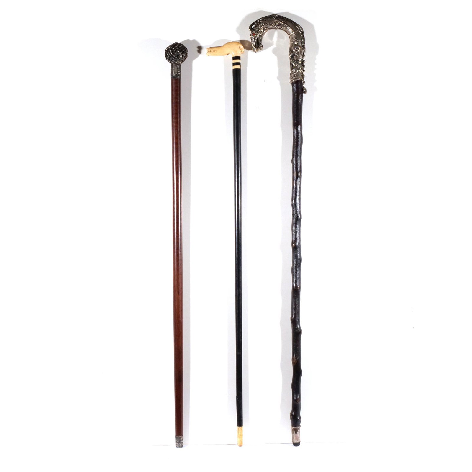 (3pc) WALKING STICKS & CANES: Including an AGA Correa sterling silver handled walking stick with a knot-form handle #9; scrimshaw cane with a carved bone & baleen dog-form handle; and a cane with a silver dragon-form handle with i