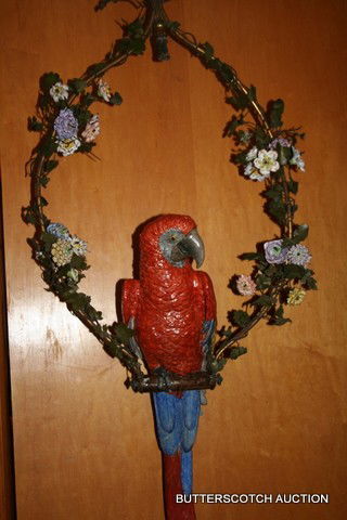251) 19THC. PORCELAIN PARROT ON SUSPENDED WIRE PERCH: W/APPLIED PORCELAIN FLOWERS, L. OF BIRD: 23", OVERALL H. ON PERCH: 45", W. PERCH FRAME: 19", ELECTRIFIED