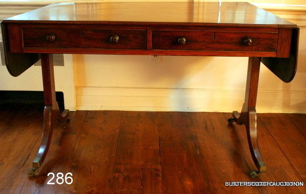 286) L. 18THC. GEORGIAN INLAID MAHOGANY SOFA TABLE,: HAVING DROP SIDES, TWO FRIEZE DRAWER W/COCK BEADING, OPPOSITE TWO FALSE DRAWERS, TRESSEL SUPPORTS W/SPLAYED LEGS ENDING IN BRASS CAPS W/CASTERS, COND.: FADED TOP, OLD REPAIR ON 1-LEG, OLD FINISH, ORIG