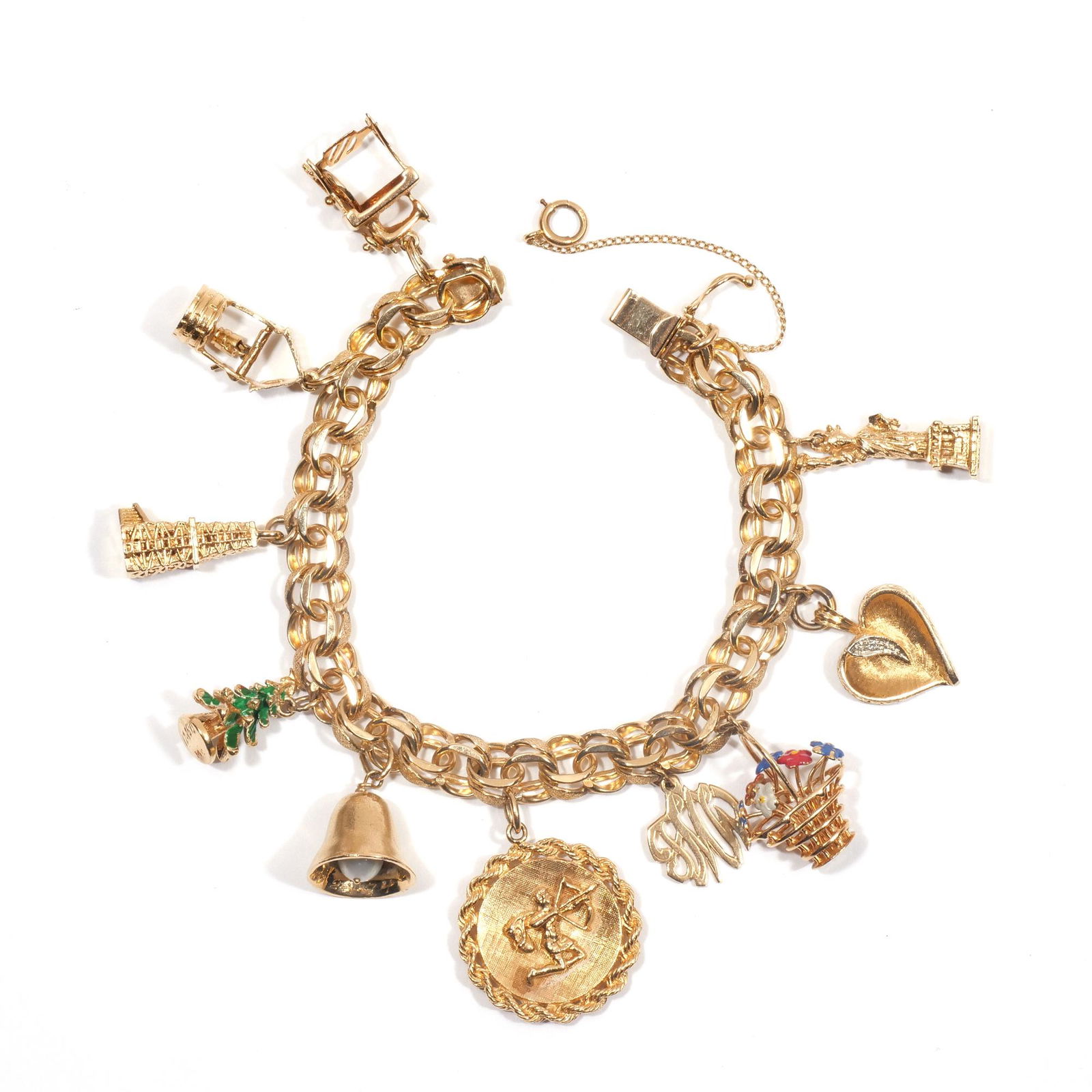 GOLD CHARM BRACELET: A 14k gold chain bracelet (pat 3308517) with mostly 14k charms, including: an articulating sewing machine and table, a wishing well with articulating pail, a windmill, a green enameled Christmas tree,