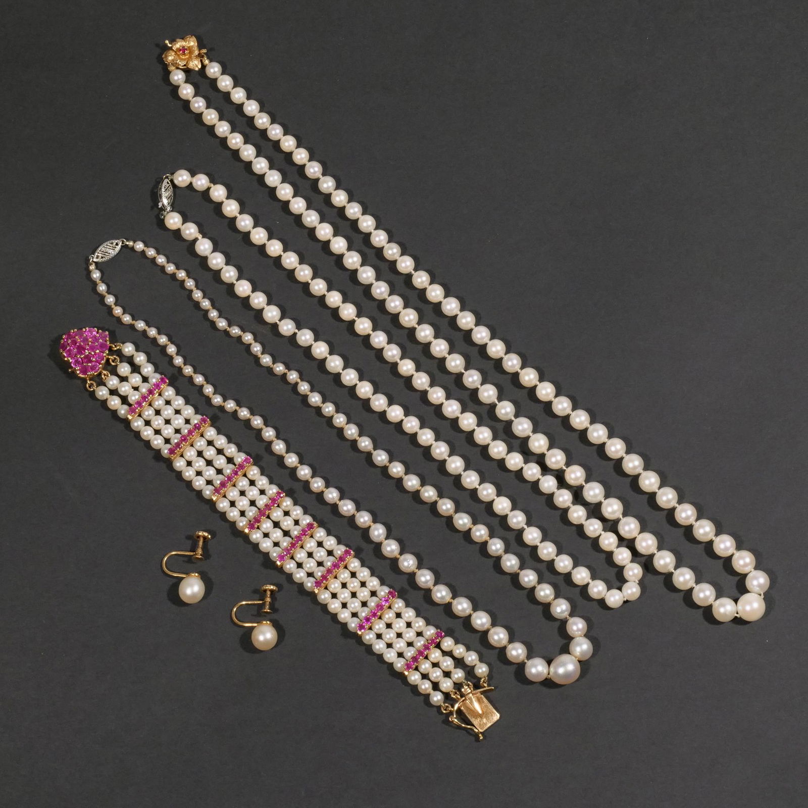(6pc) PEARL & GOLD JEWELRY: Including a four-strand bracelet with a 14k heart-shaped pink sapphire encrusted clasp and having eight bars each mounting pink sapphires (l. 6-3/4 in.), a pair of 14k screw-back earrings (approx. dia