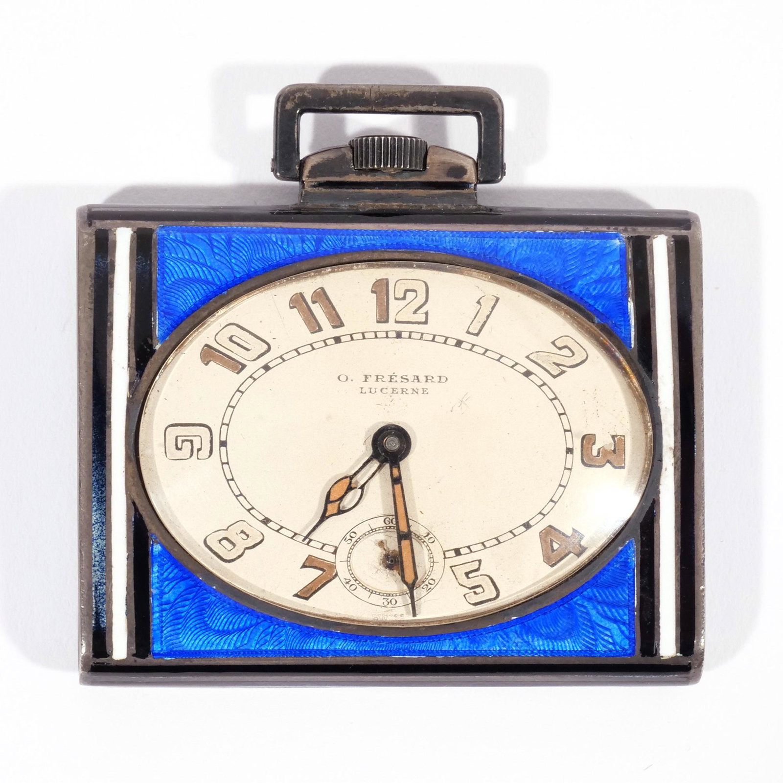 STERLING & ENAMEL SQUIRE ART DECO POCKET WATCH: Beautiful cobalt blue base enamel in translucent blue on a ground of wavy scalloped reeded engine-turning creating a moiré aspect edged in black and white enamel front and back. On face of the watch 