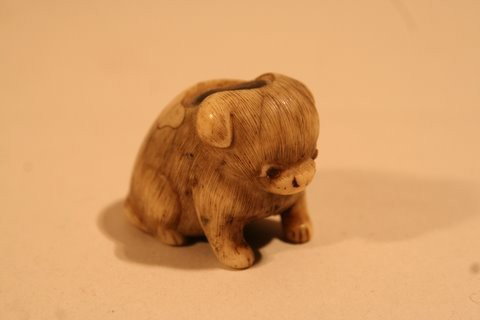 ANTIQUE CARVED IVORY NETSUKE OF SEATED DOG W/: INSERT, L. 1 ½", PROV.: GEORGE SARTON & ELEANOR MARBLE (ELWES) SARTON COLL.