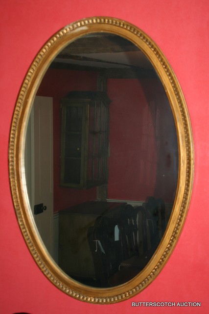 GEORGIAN -STYLE OVAL GILT CARVED FRAMED WALL: MIRROR, H. 38 ½', W. 27'