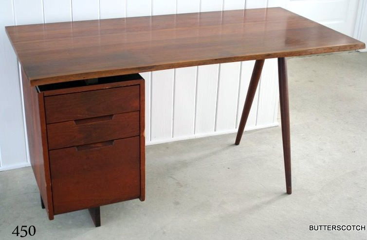 GEORGE NAKASHIMA SINGLE PEDESTAL WALNUT DESK: HAVING FREE-EDGE TOP OVER BANK OF THREE DRAWERS ANDTWIN TURNED LEG SUPPORTS, W. 54", D. 26 1/4", H. 28 1/2"