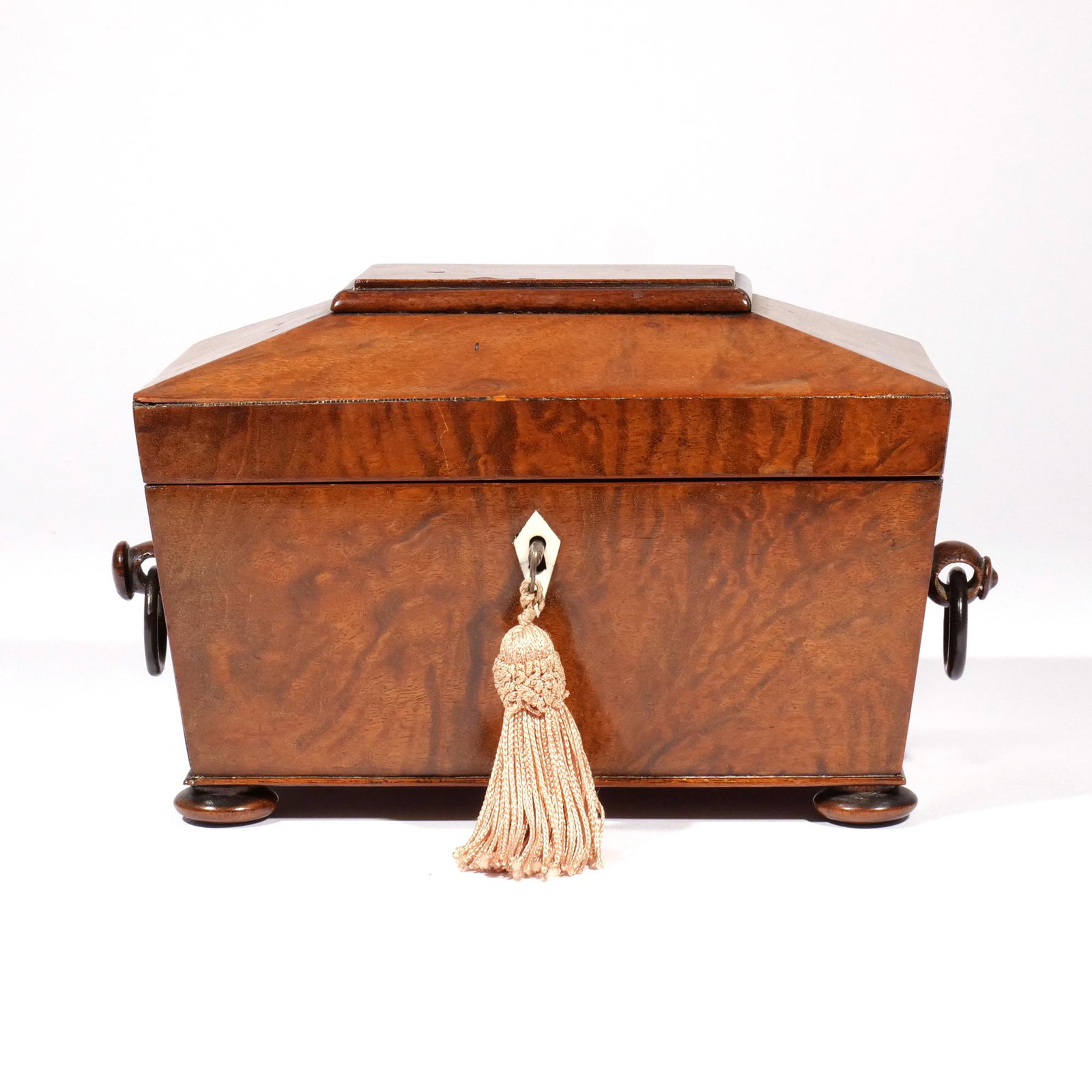 ENGLISH SARCOPHAGUS BURLWOOD TEA CADDY: 19th century, with ring side handles and bone escutcheon, interior with three lidded partitions h. 6 w. 9 d. 5-3/4 in. Provenance: Millwood, N.Y. estate [In Situ Item] This Item will not be on display