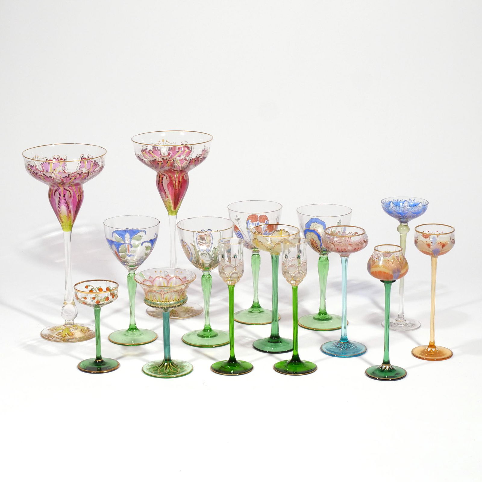 (15pc) FINE GILT & ENAMEL GLASSES: Including a pair of Honesdale by Dorflinger champagne glasses with floral enamel and gilt decoration, signed "Honesdale"; plus 13 similarly decorated glasses of smaller size, of different shapes h. 9-