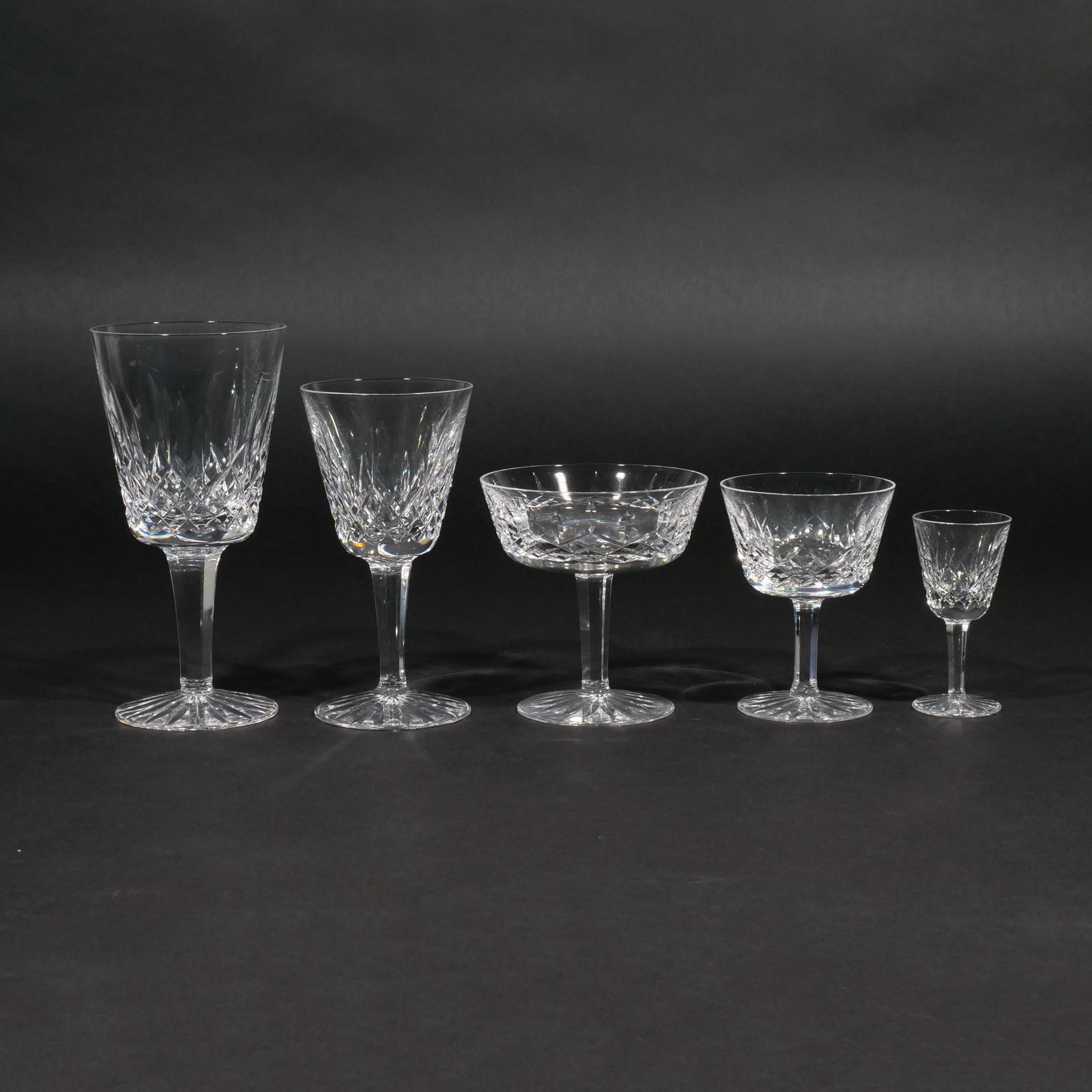 WATERFORD LISMORE DRINKWARE SET: Service for eight, comprising: 8 red wine, 8 sherry, 8 cordial, 8 champagne coupes, and 8 small cocktail glasses