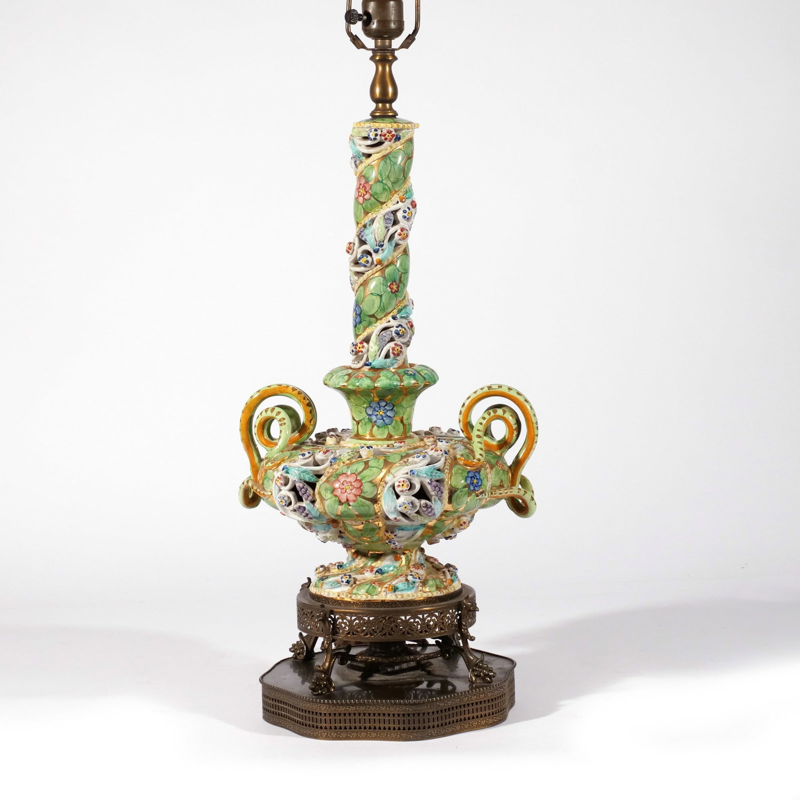 MAJOLICA VASE / LAMP, 19th century: A reticulated majolica vase of two piece construction with snake handles mounted as a lamp h. 20 w. 10 d. 9 in. (vase only) overall: h. 35 in. Provenance: Descended through the family of a celebrated 