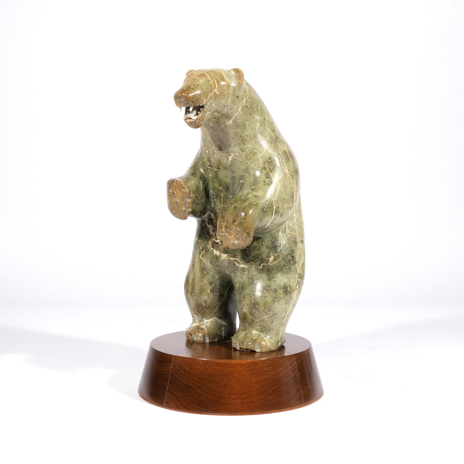 SOAPSTONE SCULPTURE OF A POLAR BEAR: 20th century, no apparent signature, bone teeth h. 10 w. 5 d. 5 in. (stone only) overall: h. 12 in. (on stand) Provenance: An important Darien, CT estate [In Situ Item] This item will not be on displa