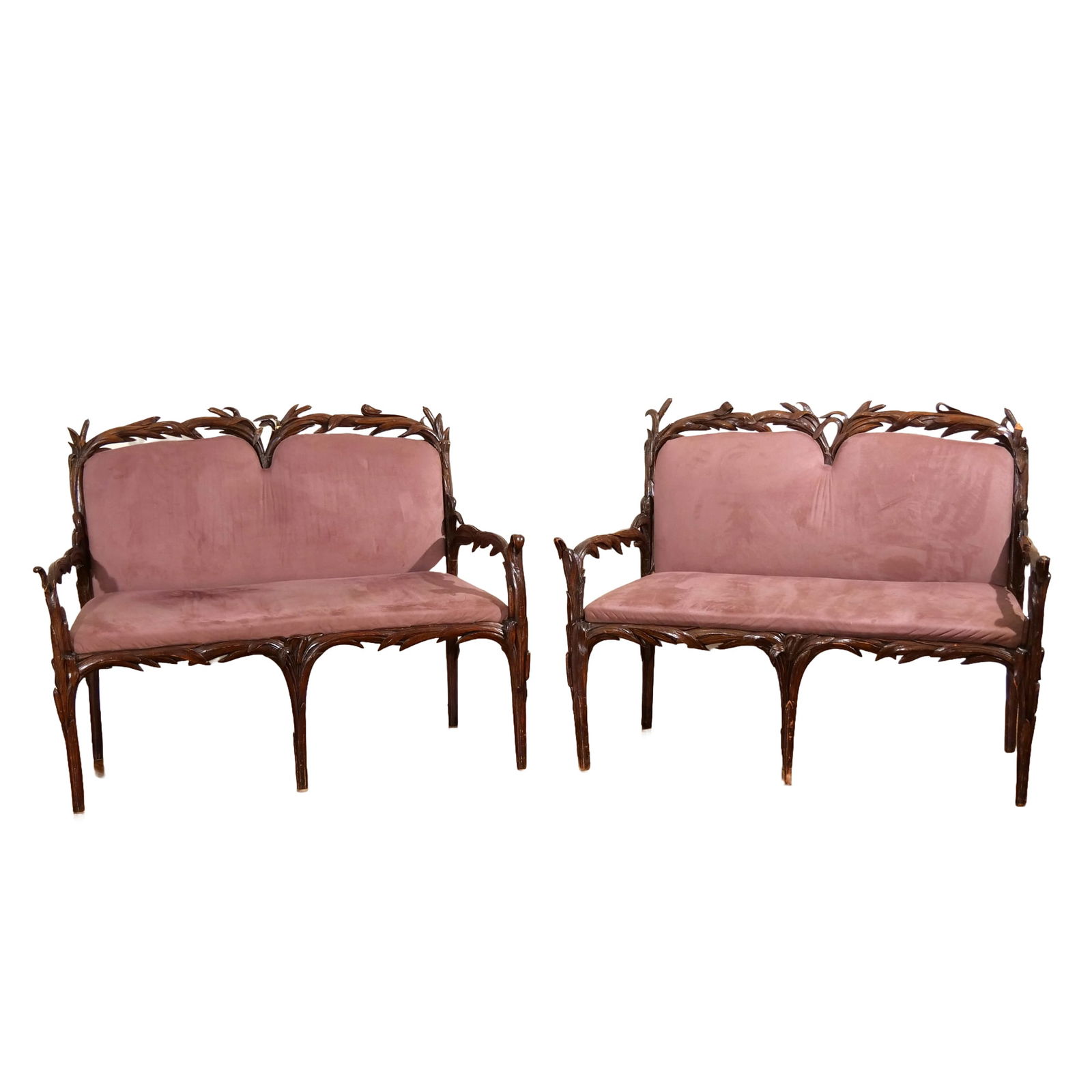 PAIR CONTINENTAL ART NOUVEAU CARVED OAK SETTEES: Early 20th century, profusely carved with cattails and other foliage h. 40-1/2 w. 50 d. 23 in. (each) Provenance: A Scarsdale, NY estate [In Situ Item] This item will not be on display in our saleroom