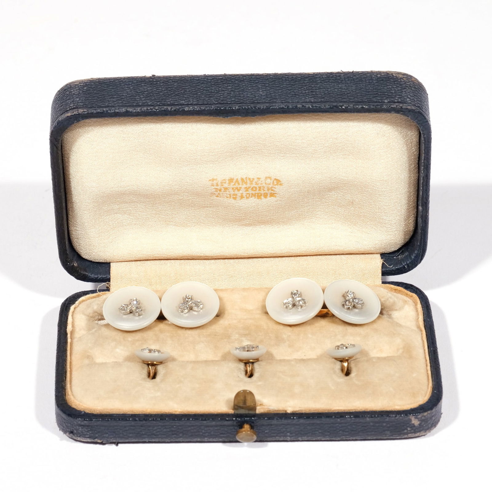 14k TIFFANY DIAMOND & MOTHER of PEARL DRESSING SET: Tiffany & Co., designed as dished circular mother of pearl buttons with central melee diamonds, set in 14k gold; accompanied by original box; 11g Provenance: Descent through a NYC estate