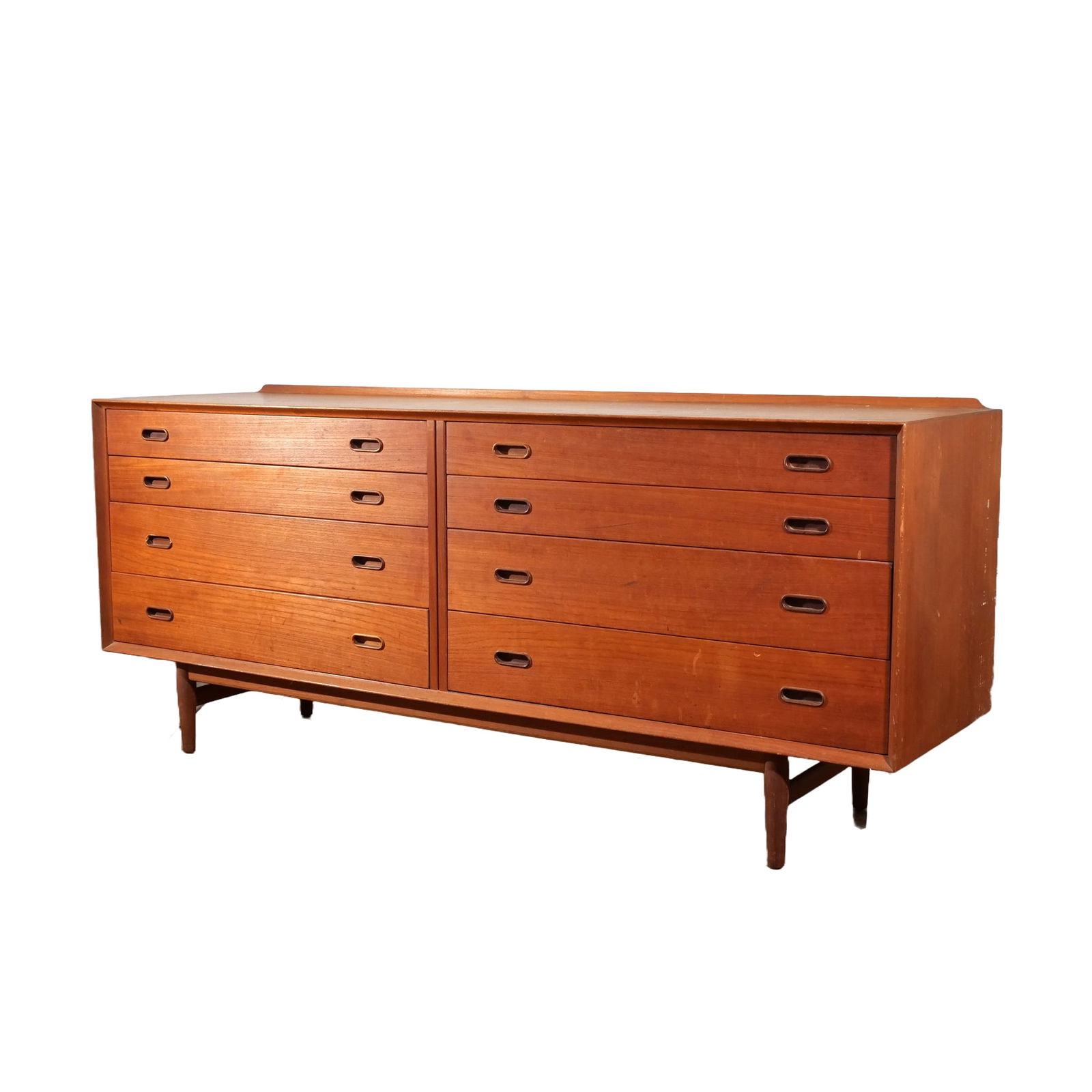 MID-CENTURY DANISH MODERN TEAK DRESSER: Possibly by Arne Vodder, c. 1960s, with eight drawers h. 31 w. 72 d. 19-1/2 in. Provenance: By descent through the family of an important South Salem, NY collector [In Situ Item] This item will not be