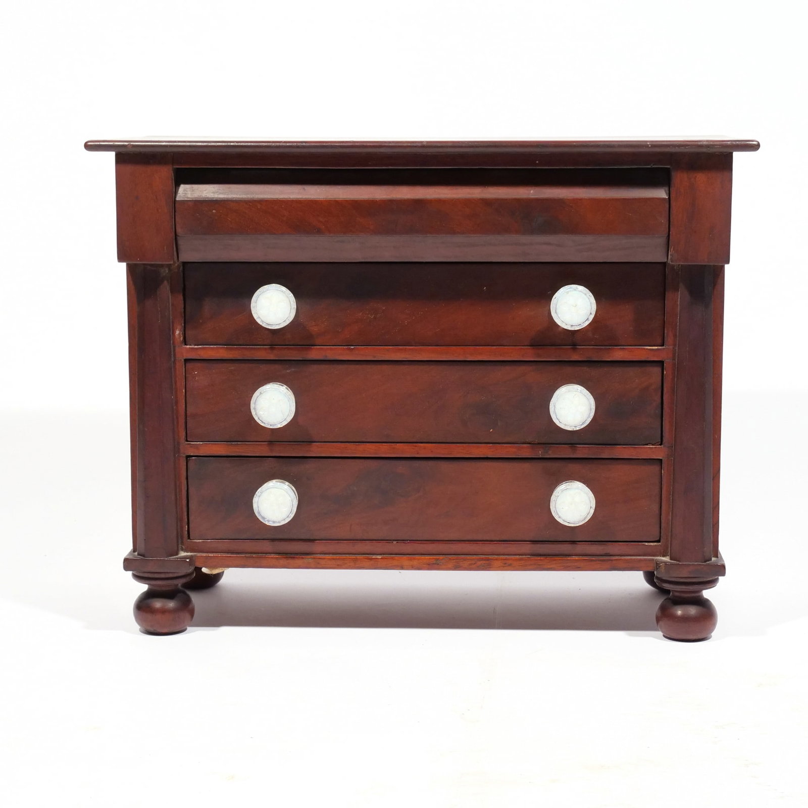 LATE FEDERAL MINIATURE CHEST: Having iridescent glass pulls h. 12-1/2 w. 16 d. 8 in. Provenance: By descent through the family of an important South Salem, NY collector [In Situ Item] This item will not be on display in our salero