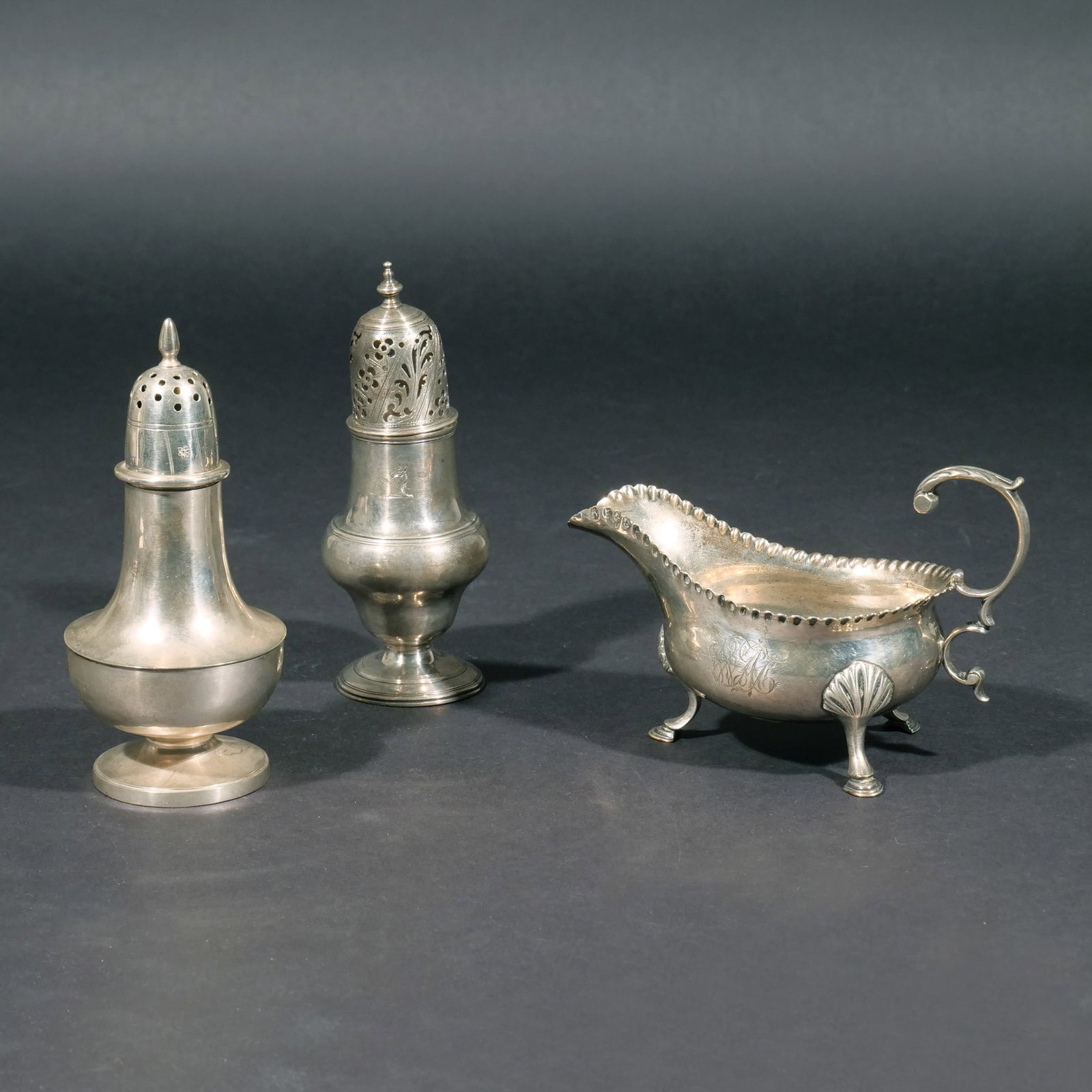 (3pc) GEORGE III & OTHER STERLING HOLLOWARE: Including a George III gravy boat c. 1763-4; a George III sugar castor c. 1784-5; and a David Carlson sugar castor; all together 14.4 ozt Provenance: Descended through a Greenwich, CT estate