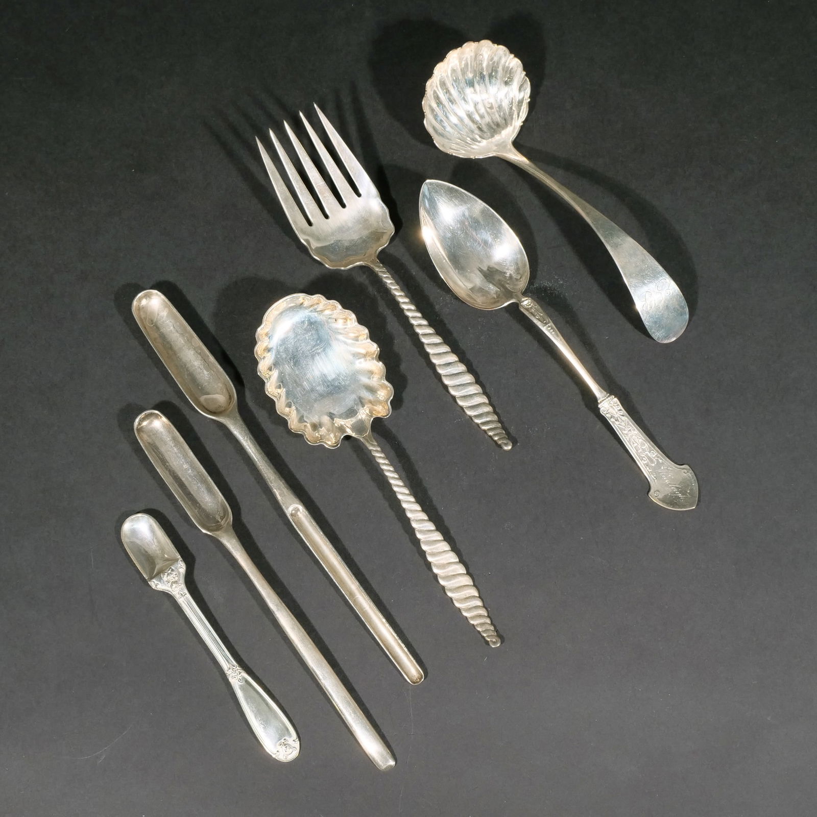 (7pc) MISC. STERLING SILVER SERVING PIECES: Including a two piece Whiting serving fork and spoon set in "Oval Twist" pattern; two Georgian bone marrow spoons with hallmarks; a 7-1/2 inch ladle with shell-form bowl; a Gorham serving spoon with e