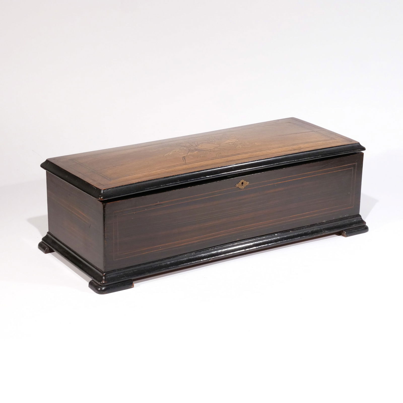 SWISS MUSIC BOX: With inlaid lid, original tune sheet h. 7 w. 23-1/2 d. 10 in.Provenance: Descended through a Greenwich, CT estate [In Situ Item] This item will not be on display in our saleroom during our preview per