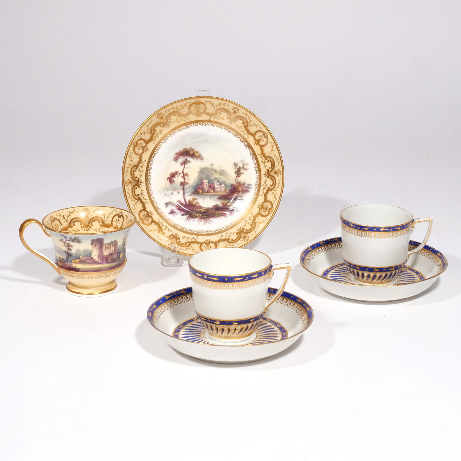 (6pc) MID-18th C. DERBY CUPS & SAUCERS: A pair of Derby tea cups and saucers with cobalt and gold decoration, plus a topographical tea cup with a dish of similar pattern depicting a country scene h. 3-1/4 in. (tallest) dia. 5-7/8 in. (wides
