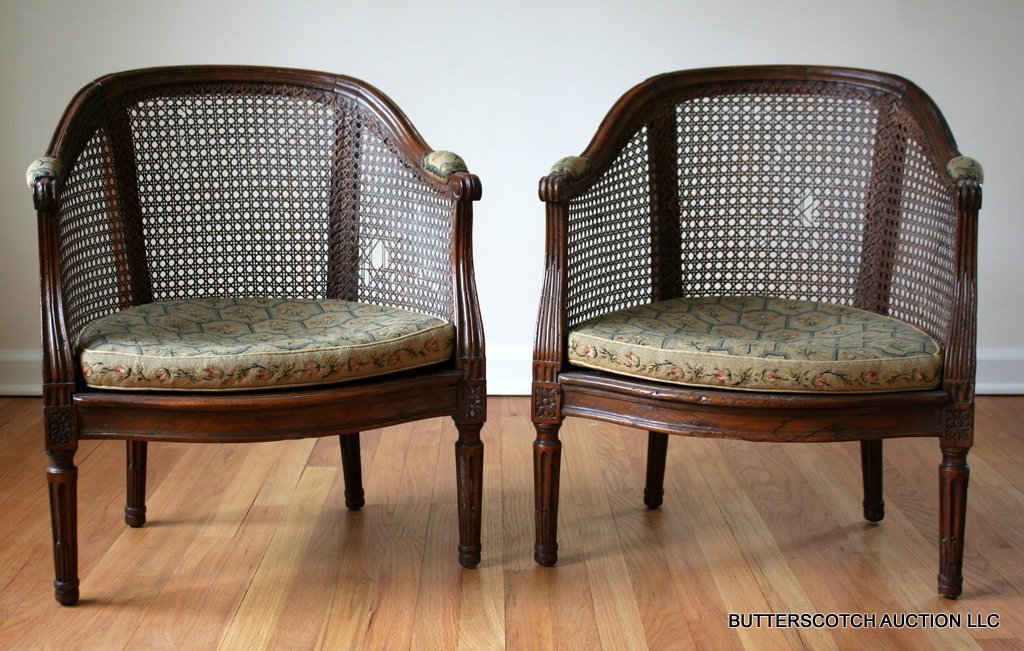 60) PAIR LOUIS XVI SLIPPER CANNE' CHAIRS,: HORSESHOE-SHAPED CREST RAIL W/SHAPED ARM SUPPORTS, SERPENTINE SEAT RAIL W/PATERA CARVING ON KNEE LEGS W/STOP FLUTING BACK AND FRONT, CANE SEATS W/ LOOSE CUSHIONS; SLIGHT VARIATION IN ARM SUPPORTS, ONE