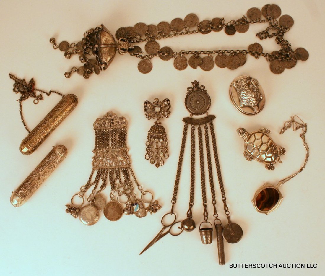 1155) 9 PCS. MISC. COSTUME JEWELRY:: 155) 9 PCS. MISC. COSTUME JEWELRY: ONE PEWTER NEEDLE-WORK CHATELAINE (10 ¼"), ONE ENGLISH SILVER (?) CHATELAINE, UNMARKED (6 ½"), ONE TURTLE SHAPED CLIP MARKED "950 MEXICO" (3 ¼", 2 TOZ), ONE TURTL