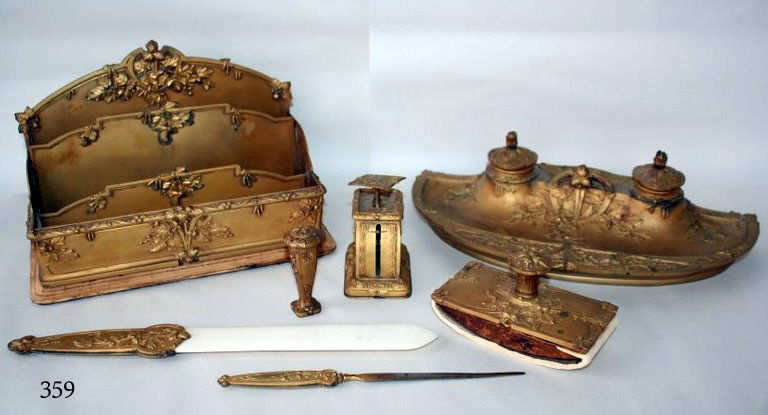 359) 7 PIECE GILT-ORMOLU LOUIS XV- STYLE DESK SET,: EACH PIECE SIGNED "GUENDARDEAU SCULPT. SUSSE FRERES.; PEN TRAY: L: 13" H: 3 ½" D: 6 ¾"; TIERED LETTER RACK; SCALE; PAGE TURNED W/IVORY BLADE; SEAL; LETTER OPENER; ROCKER BLOTTER